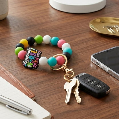 Colorful beaded keychain with keys on a wooden surface